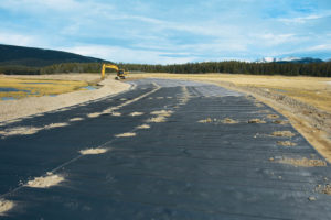 FIGURE 8: Wicking geosynthetic installed. Small aggregate piles were used to hold the geosynthetic in place in windy conditions. 