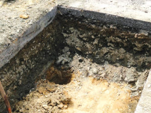 Photo 3: Deeper spot excavation reveals the clayey subgrade.