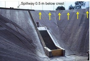 Figure 3 Southwest end of the reservoir showing: water intake structure, spillway, and butyl rubber geomembrane.