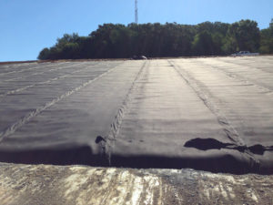 Geotextile overlap and seams, with geocomposite installed in anchor trench and along slopes. Photo: GSE 