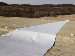 Photo 5: White-surfaced HDPE geomembrane installed over compacted clay liner. Photo: AECOM