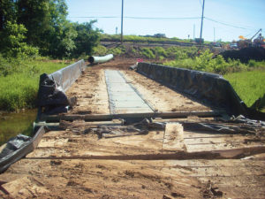 Bridge lined with geotextile fabric during pipeline installation.