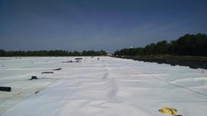 Photo 3 A white 80-mil HDPE geomembrane was installed, stretching across the entire 12-acre basin.