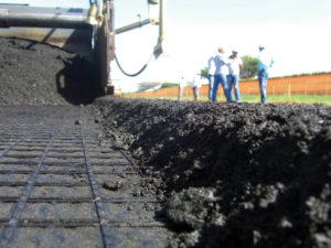 View of a geogrid placed as pavement interlayer system, which aims at minimizing reflection of pre-existing cracks into the new asphalt overlay. Photo courtesy of Andre Silva, Huesker. 