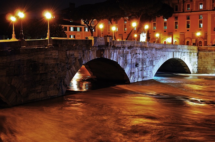 Photograph of the Pons Cestius (Ponte Cestio) over the Tiber River at night in Rome, Italy, site of the 12 ICG.