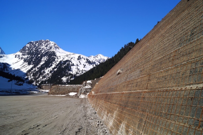 Geosynthetic protective dam from TenCate Geosynthetics prevents rockfall from falling on gondola station in Austria.