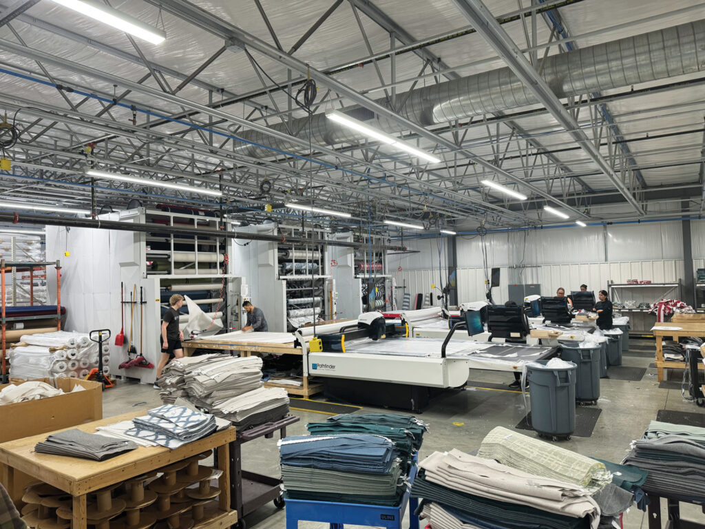 The factory floor showing three M-Series machines in use at Poly-Wood LLC, in Syracuse, Ind., cutting fabric for cushions for outdoor furniture.